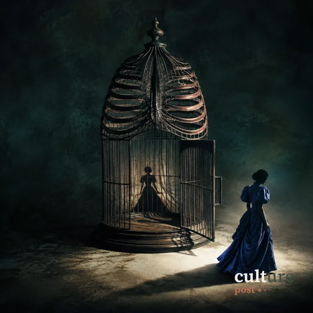 A wire birdcage shaped like a ribcage beside a woman in a blue dress